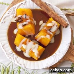 Candied Mexican Pumpkin (Calabaza en Tacha) Recipe 4 Mexican candied pumpkin on a white dish with brown sugar syrup, a cinnamon stick and drizzled with sweetened condensed milk