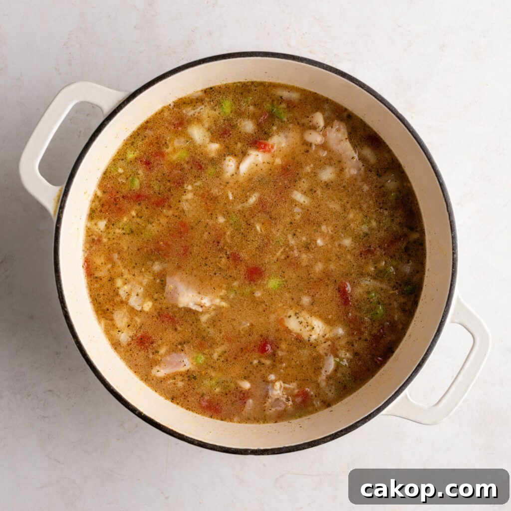 Southwest Chicken Chili: Spicy Crockpot Recipe for Weeknights 5 a pot of southwest chicken chili cooking