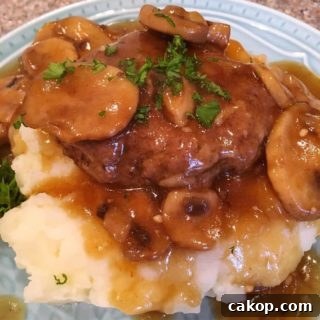 Salisbury Steak on top of mashed potatoes.