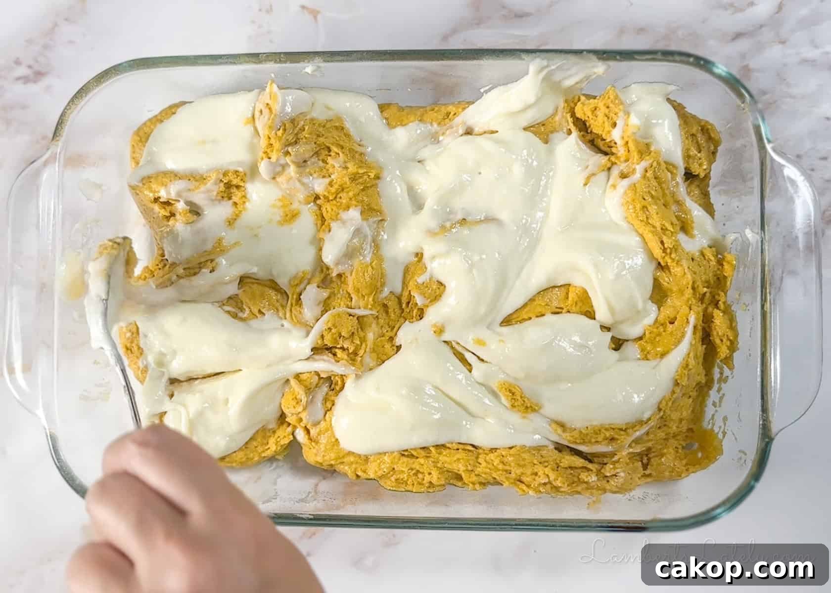 swirling cream cheese into unbaked pumpkin bar batter.