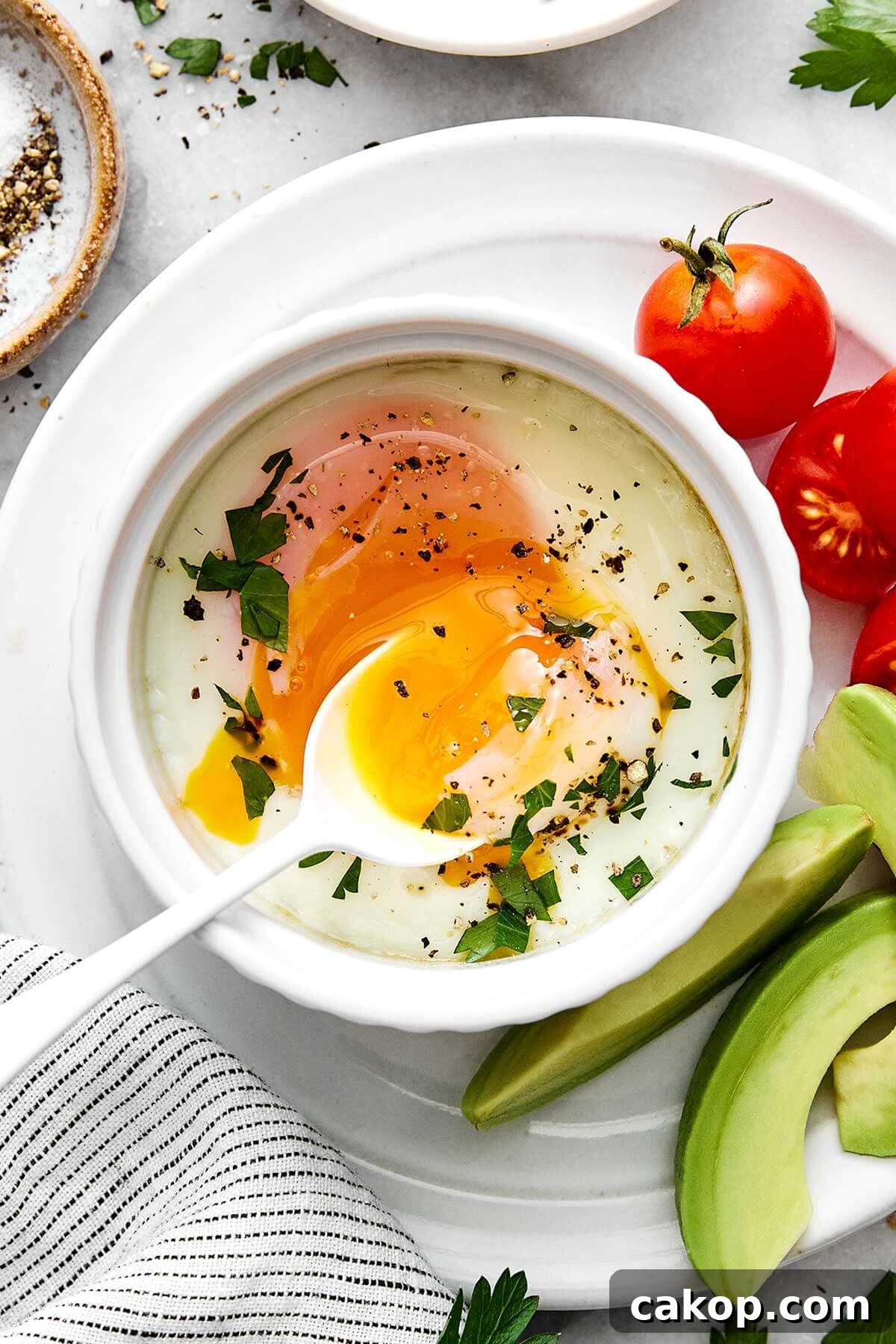 6 Quick Ways to Cook Eggs for Every Meal 2 Baked eggs on a plate with tomatoes and avocado is one way to cook eggs.
