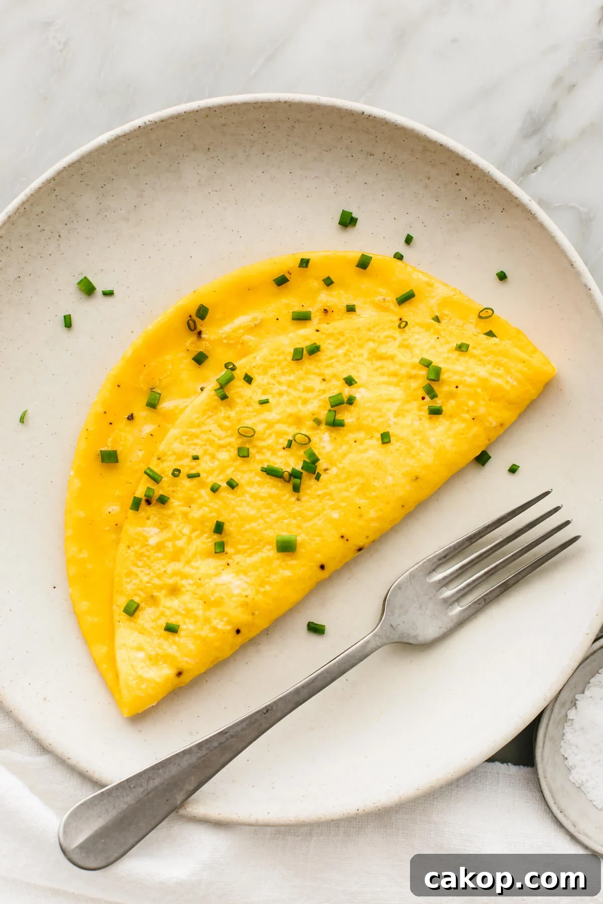 6 Quick Ways to Cook Eggs for Every Meal 8 A plate with an omelette and a fork