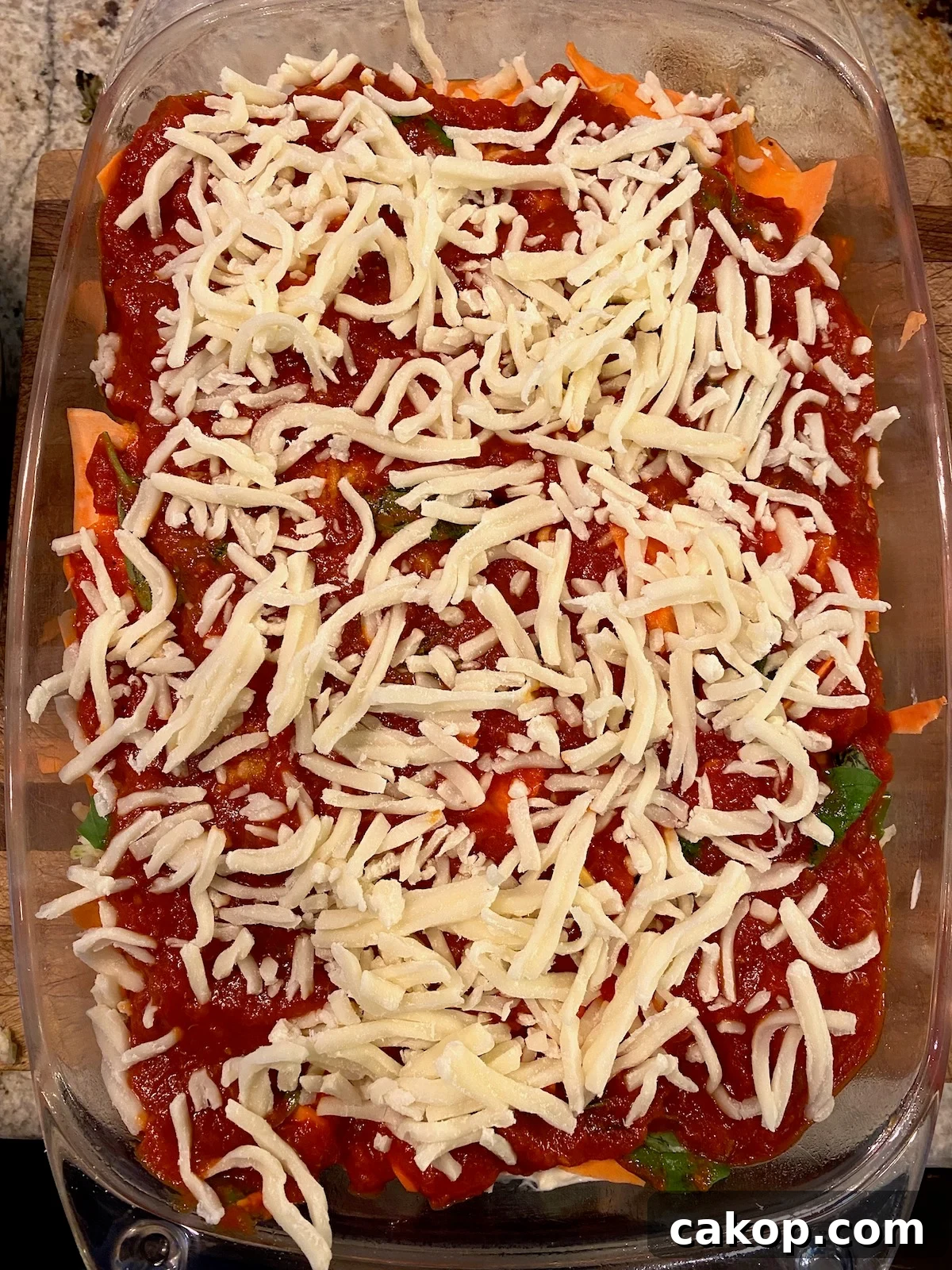 Sweet Potato Lasagna Recipe with Creamy Ricotta and Spinach 11 Shredded mozzarella cheese on top of marinara sauce.