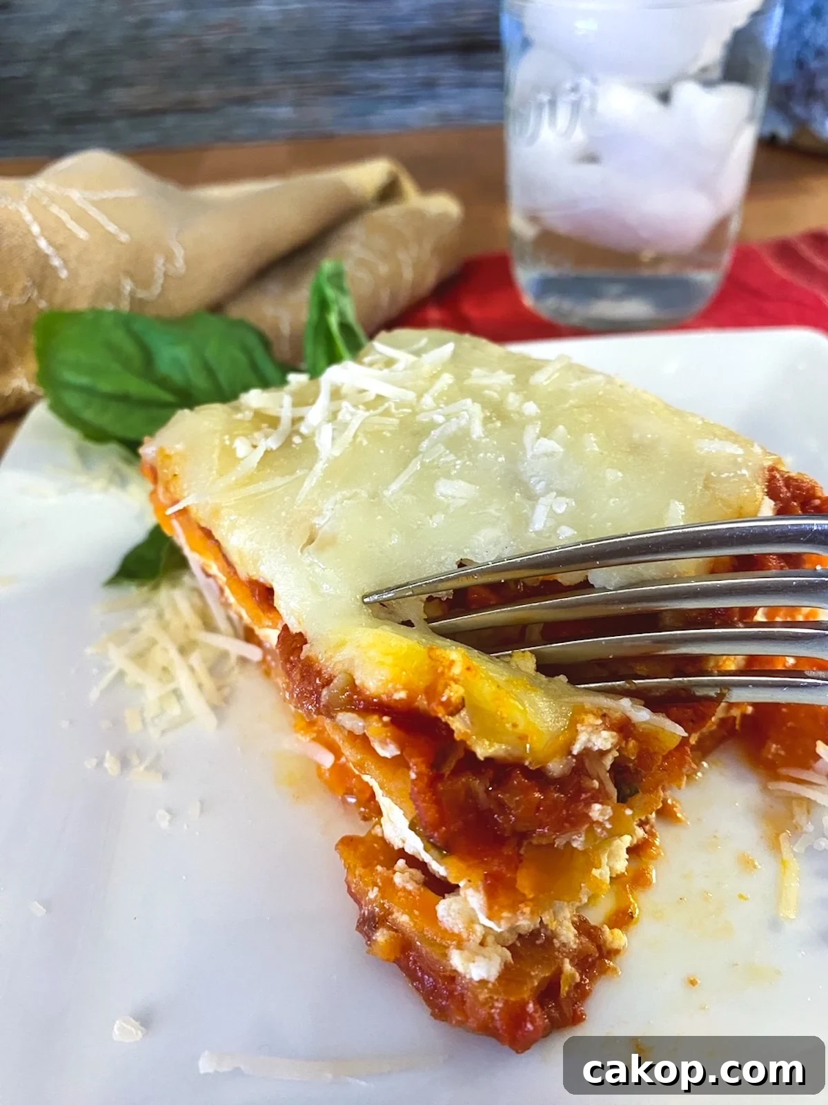 Sweet Potato Lasagna Recipe with Creamy Ricotta and Spinach 3 A wedge of sweet potato lasagna with a fork.