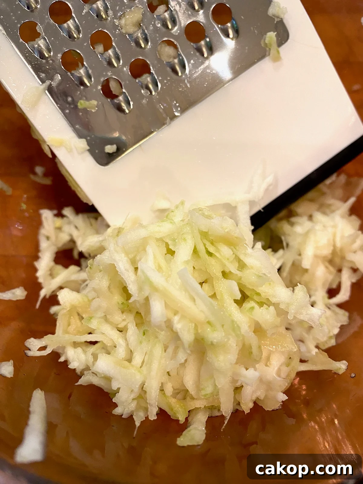 Sweet Potato Lasagna Recipe with Creamy Ricotta and Spinach 5 Grated elephant garlic in a bowl with a grater on the side.