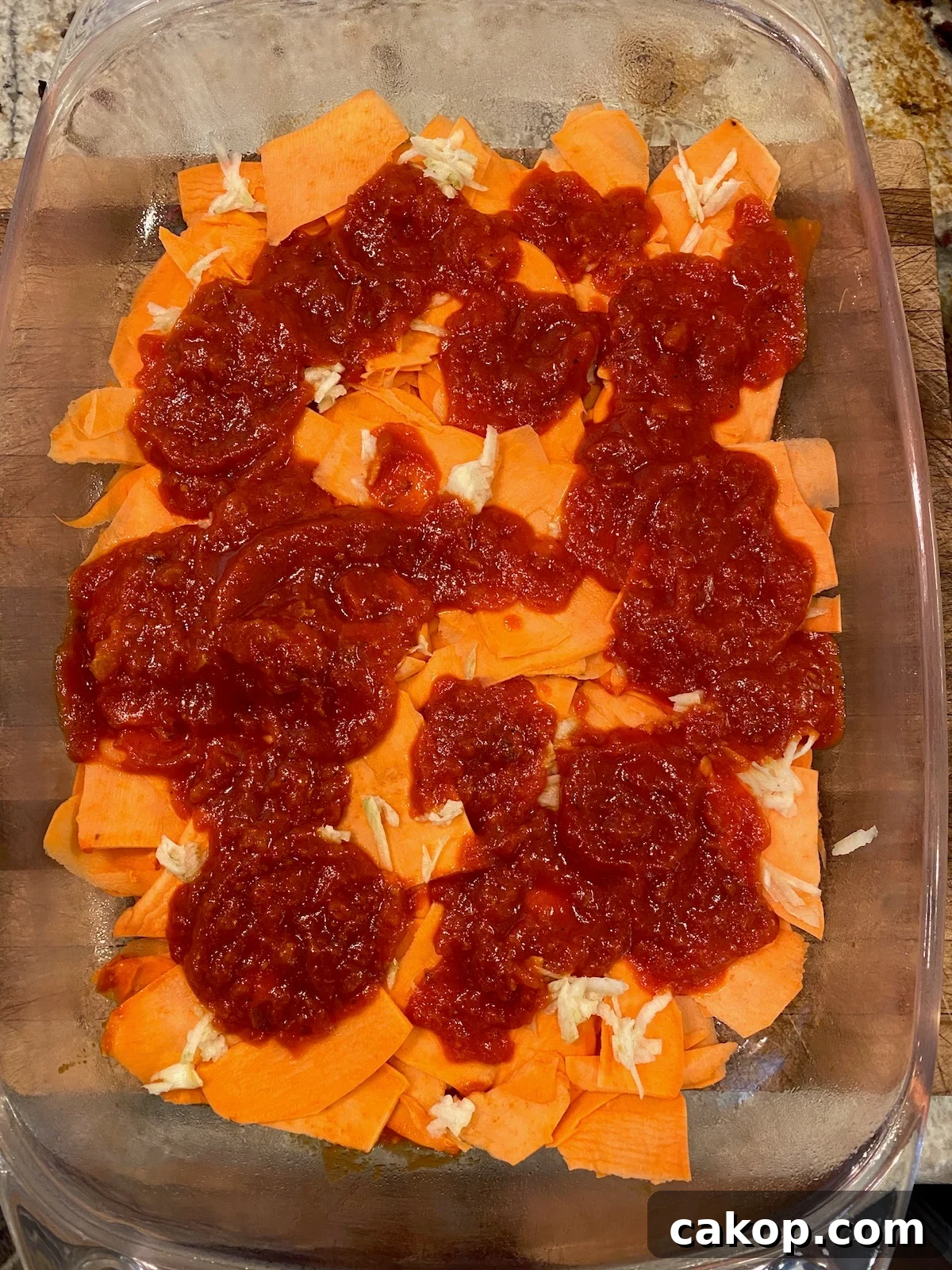 Sweet Potato Lasagna Recipe with Creamy Ricotta and Spinach 8 Marinara sauced placed on top of sliced sweet potatoes.