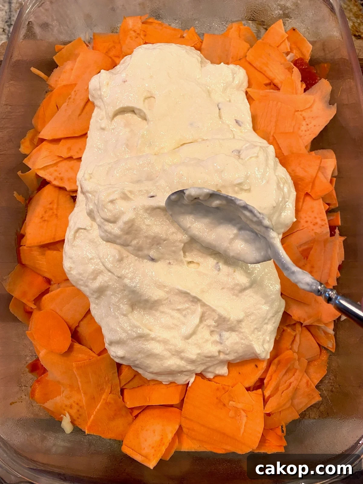 Sweet Potato Lasagna Recipe with Creamy Ricotta and Spinach 9 Ricotta cheese layer spread on top of sliced sweet potatoes in a baking dish.