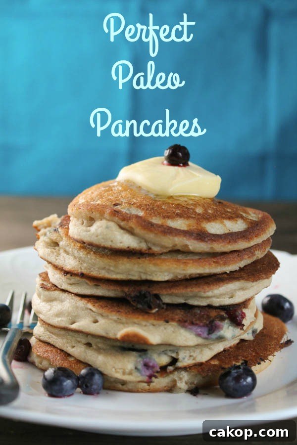 Delicious Breakfast Recipes to Energize Your Morning 7 Perfect Paleo Pancakes, pancakes stacked on a plate with blueberries and butter on top