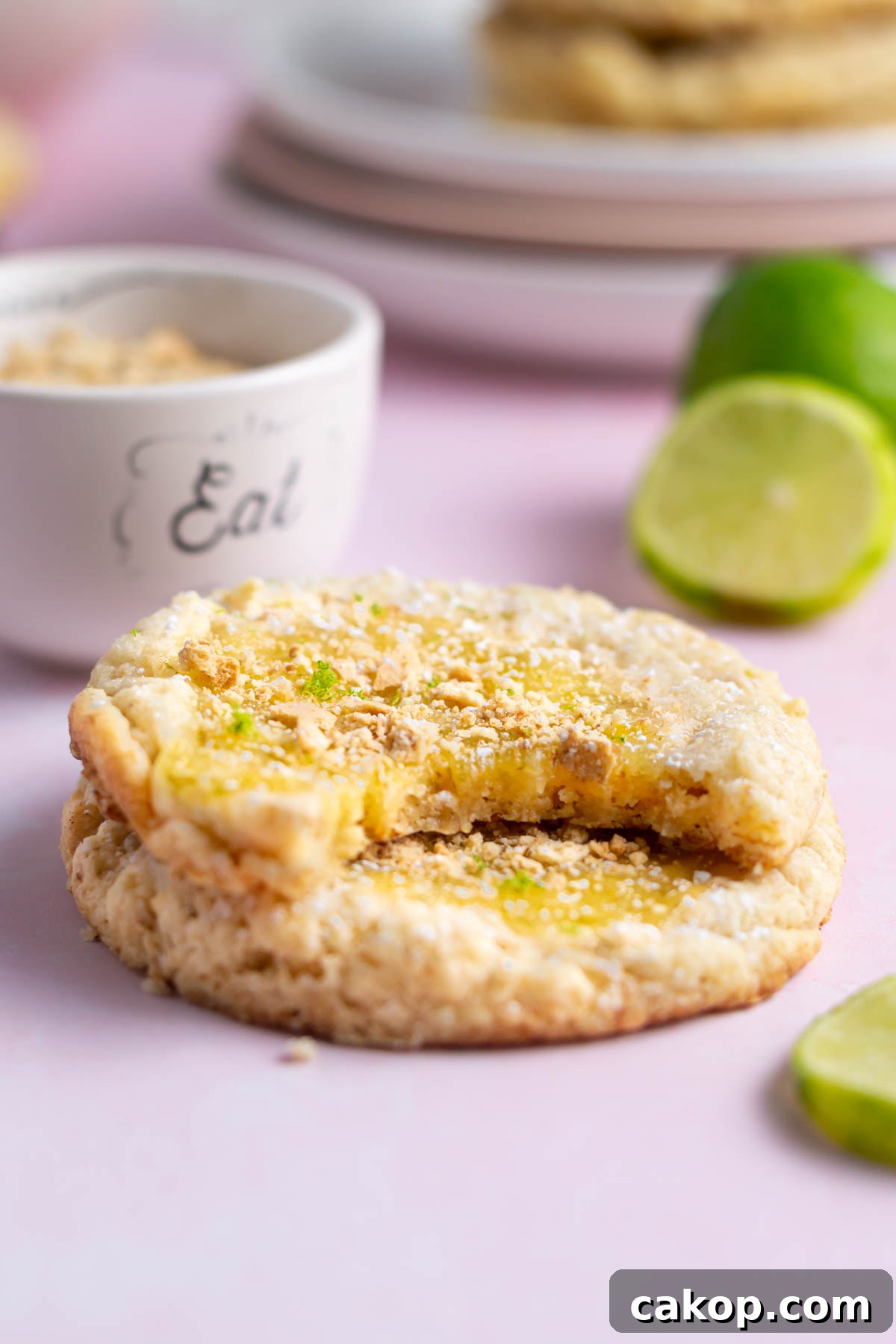 key lime cookie with a bite missing sitting on top of another cookie