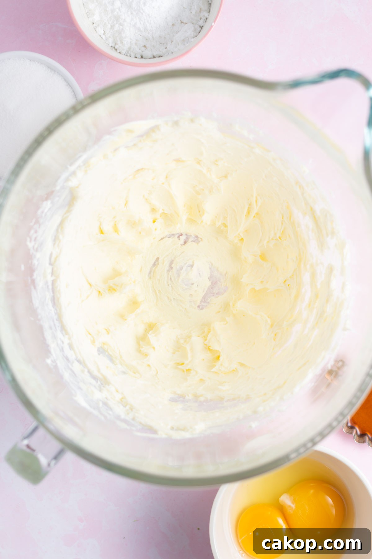 butter and cream cheese beat together in a mixing bowl