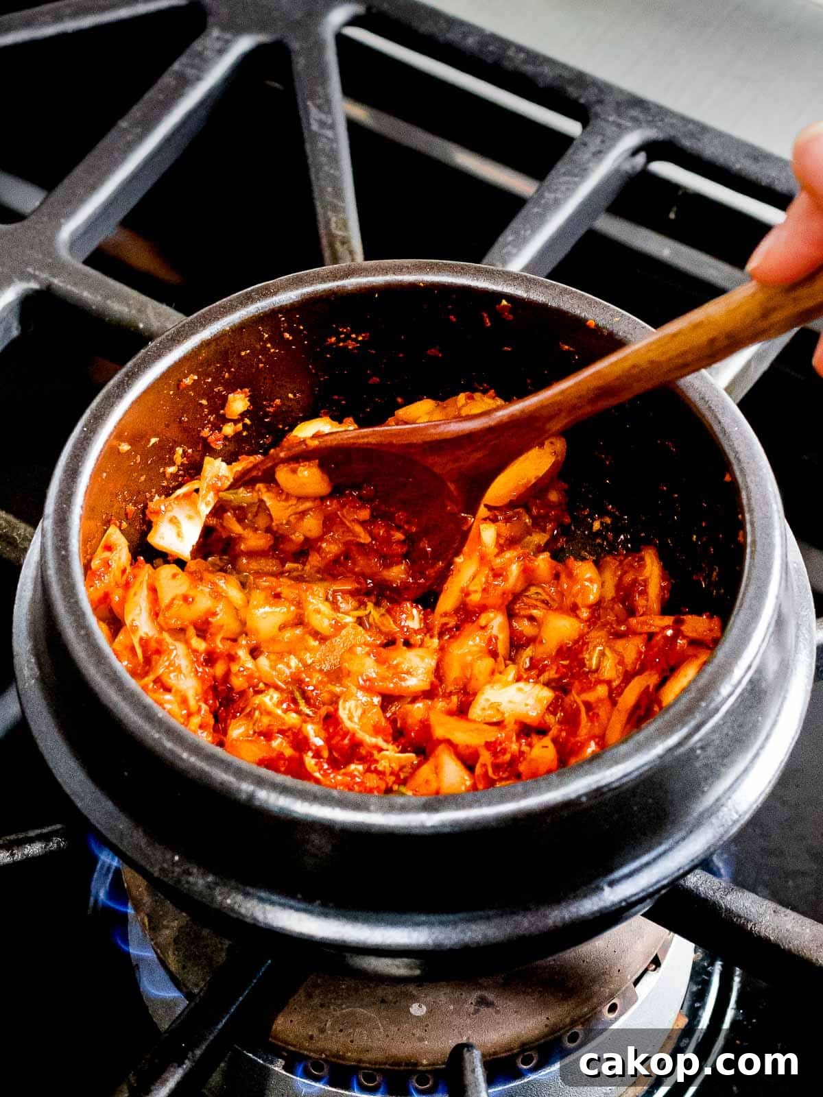 Spicy Korean Soondubu Jjigae (Silken Tofu Stew Recipe) 5 Soondubu seasoning with kimchi and red pepper flakes sauteed in oil.